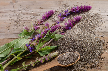 Chia seeds healthy superfood with flower on wooden table