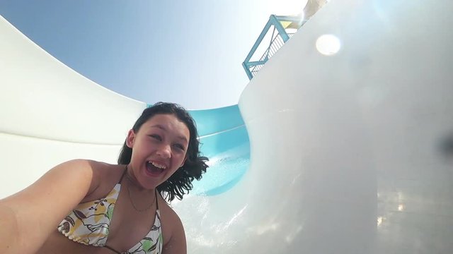 funny girl and water slide, slow motion