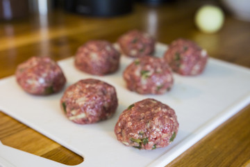Making meatballs in a kitchen 
