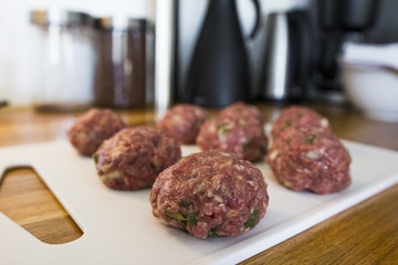 Making meatballs in a kitchen 