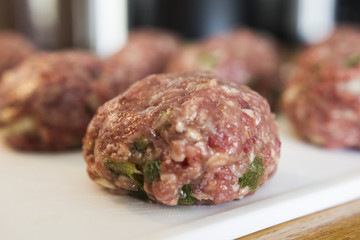 Making meatballs in a kitchen 