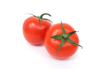 Two tomatoes with a sprig on a white background. Ripe red vegetables. Close up.    