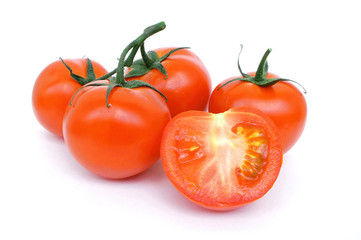 Sprig of ripe tomato on white background. A half of a tomato. Close up. Juicy ripe vegetables. 