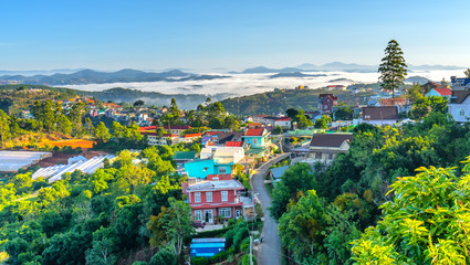 Landscape morning in small village in the valley on the plateau, distant fog shrouded the great hidden house on the outskirts of Dalat, Vietnam