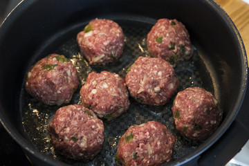 Making meatballs in a kitchen 