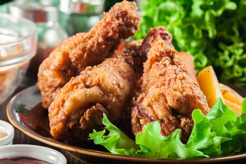 Crispy fried kentucky chicken legs with french fries