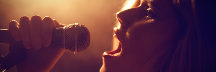 Close-up of woman singing at concert