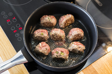 Making meatballs in a kitchen 