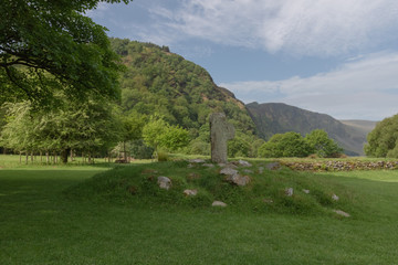 Fototapeta na wymiar Celtic cross, grave hill, against beautiful mountain range, tranquil peaceful scene