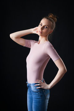 high fashion portrait of young elegant woman in beige top and jeans. Studio shot