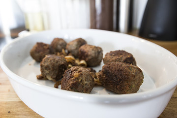 Making meatballs in a kitchen 