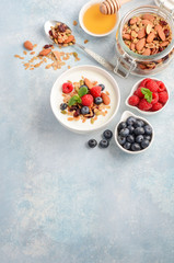 Homemade granola with yogurt and fresh berries, healthy breakfast concept, selective focus, copy space.