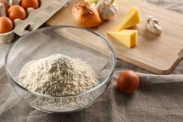 flour in a glass Cup on the background of other ingredients for dough