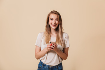 Portrait of a pretty casual girl holding mobile phone