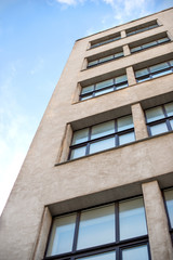  Fragment of a gray high-rise building built in the 1930s of the 19th century, view from below