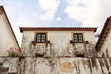 Narrow and colorful streets, facades and balconies of Obidos