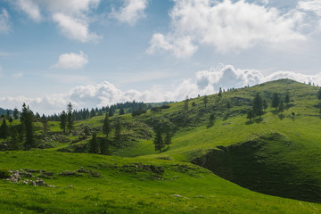 Beautiful mountain landscape with green hills and blue sky