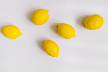 A few lemons on grey background. Flat lay, top view. Copy space, header for blog 