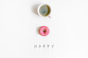Top view Cup of coffee,pink Donut and candles with word Happy. Flatlay