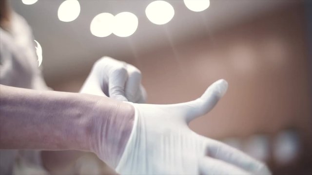 Close-up shows the doctor's hands.