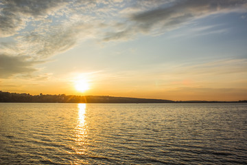 poor city lake waterfront horizon in evening sunset time with soft blue and orange colors