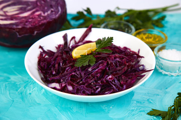 Shredded red cabbage in bowl.