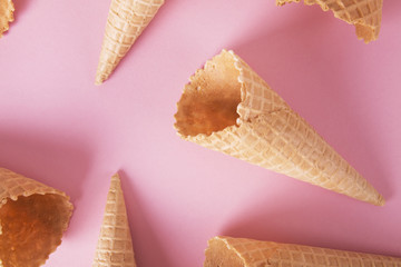 Empty cone wafers on a pink background.