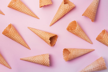 Empty cone wafers on a pink background.