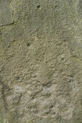 Texture of aged and worn tombstone close up