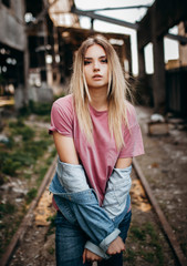 Fototapeta premium Outdoor lifestyle portrait of stylish girl teenager stay on the rails of city