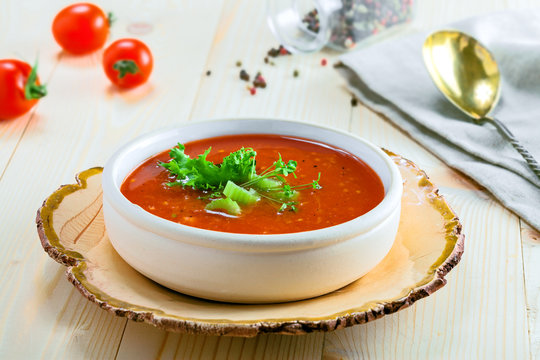 Gazpacho in a bowl, ingredients and bread. Classic Spanish cuisine vegetarian soup.