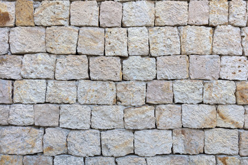 Texture of a stone wall from a large cobblestone shell closeup