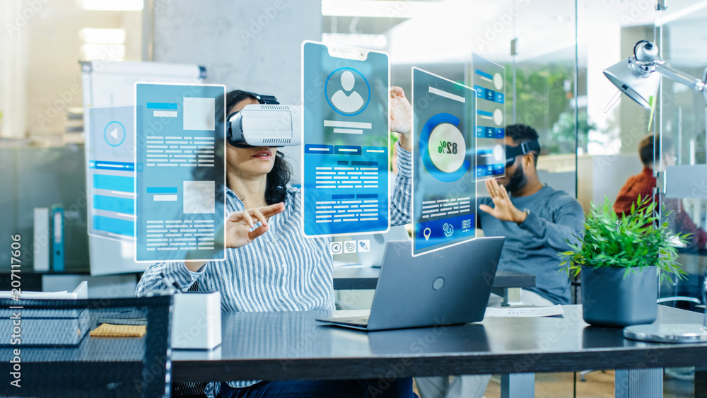 Poster female virtual reality engineer/ developer wearing virtual reality headset creates content with her 