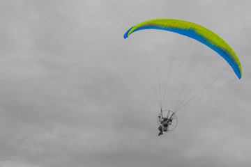 Para-motor flying on the Black and White sky.