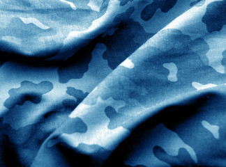Military uniform pattern with blur effect in navy blue tone. © pavelalexeev