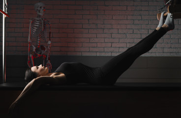a woman is engaged in Pilates. fitness and sports