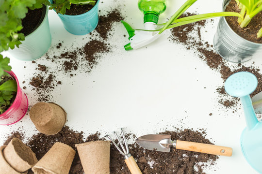 Photo of soil, watering can, flower pot, shovel, rake on empty white background.