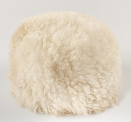 White caucasian papakha, of sheepskin, on white background