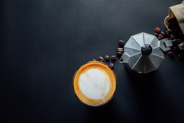 Fototapeta premium Latte art ,Croissant and moka pot with Roasted coffee on black background in the morning top view and instagram style filter photo vintage tone