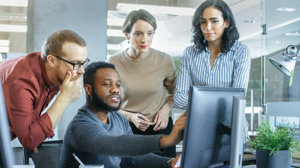 In Busy Corporate Office Team of Diverse Young Creative People Work on a Problem Solution. Collectively They Try to Help Coworker to Solve Problem.
