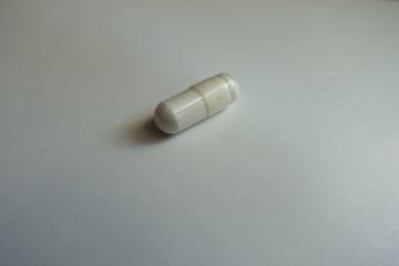 Closeup of white capsule of magnesium citrate