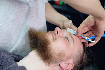 man is bearded and shaved in barbershop