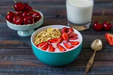 Granola with berries in yogurt. Healthy breakfast with strawberries and cherries