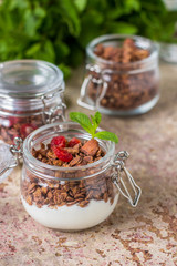 Chocolate granola in the jar, healthy breakfast