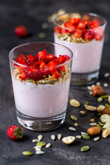 Granola with yogurt, strawberry and nuts, healthy breakfast
