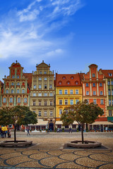 Fototapeta na wymiar Wroclaw Market Square with old colorful houses against bright blue sky. Mid day sunlight in historical capital of Silesia Poland, Europe. Travel vacation concept