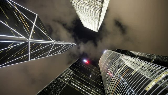 Low angle view of clouds moving over tall office buildings including the Bank of China, Central, Hong Kong, China, T/lapse