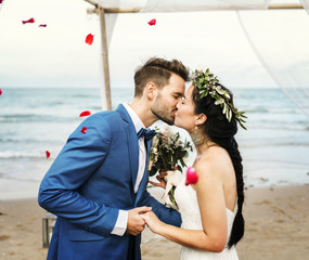 Young couple kissing at wedding reception