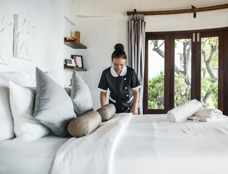 Housekeeper Cleaning A Hotel Room