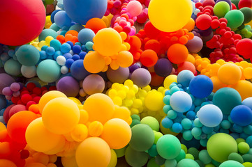 Bright abstract background of jumble of rainbow colored balloons celebrating gay pride - 207122621